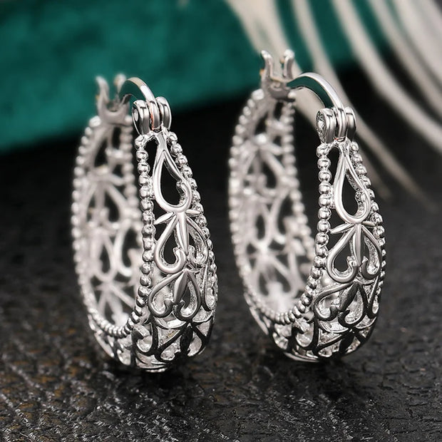 Vintage silver filigree hoop earrings with intricate designs, ideal for jewelry websites, jewelry storage, vintage jewelry collections, and gifting for mom.