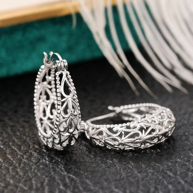 Vintage silver filigree hoop earrings with intricate designs, ideal for jewelry websites, jewelry storage, vintage jewelry collections, and gifting for mom.