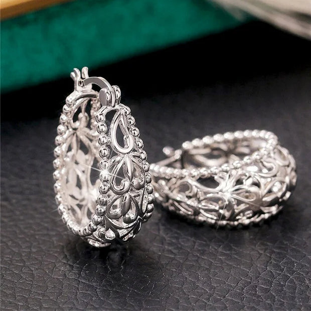 Vintage silver filigree hoop earrings with intricate designs, ideal for jewelry websites, jewelry storage, vintage jewelry collections, and gifting for mom.