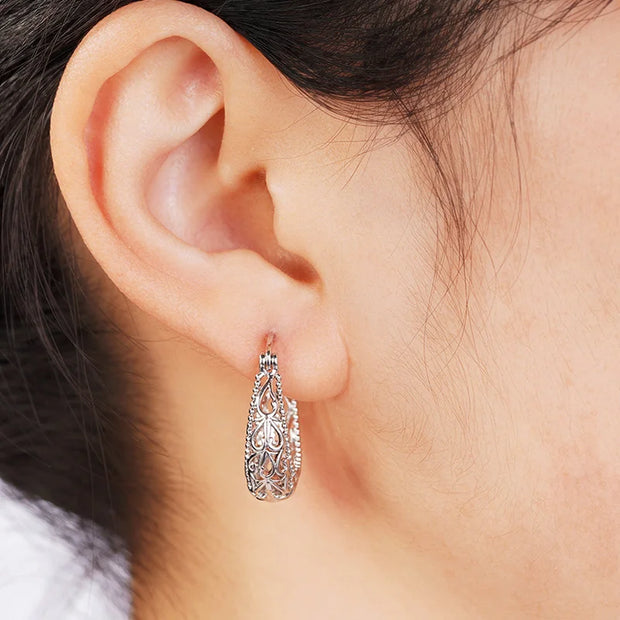 Vintage silver filigree hoop earrings with intricate designs, ideal for jewelry websites, jewelry storage, vintage jewelry collections, and gifting for mom.