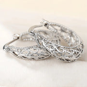 Vintage silver filigree hoop earrings with intricate designs, ideal for jewelry websites, jewelry storage, vintage jewelry collections, and gifting for mom.