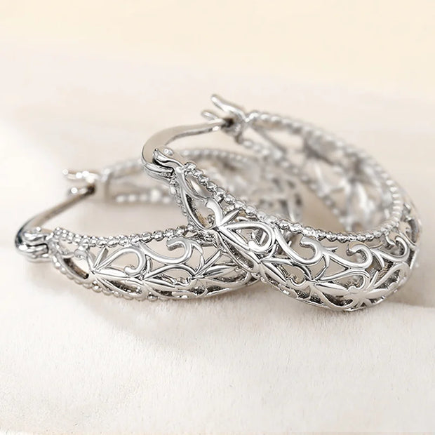 Vintage silver filigree hoop earrings with intricate designs, ideal for jewelry websites, jewelry storage, vintage jewelry collections, and gifting for mom.