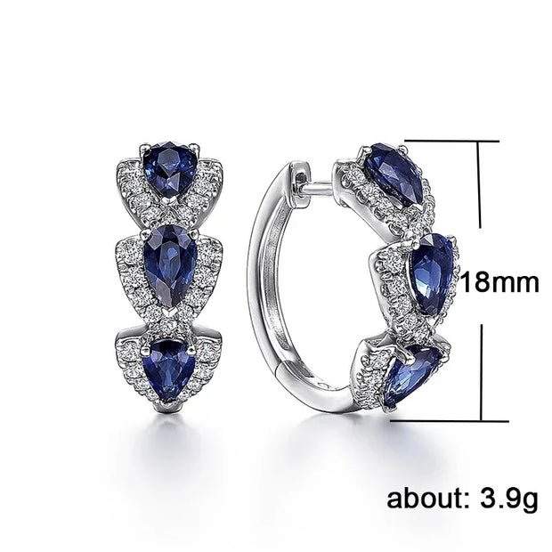 Silver hoop earrings with blue sapphires and crystals, ideal for jewelry websites, jewelry storage, gem jewelry, and gifting for mom or elegant occasions.