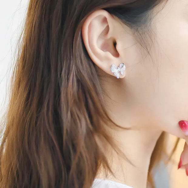 Dazzling bow-shaped stud earrings with crystals, perfect for jewelry storage, jewelry websites, vintage jewelry collections, and as gifts for jewelry lovers.