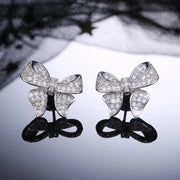 Dazzling bow-shaped stud earrings with crystals, perfect for jewelry storage, jewelry websites, vintage jewelry collections, and as gifts for jewelry lovers.