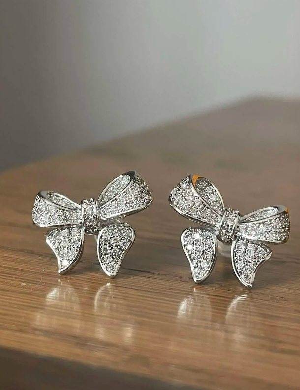 Dazzling bow-shaped stud earrings with crystals, perfect for jewelry storage, jewelry websites, vintage jewelry collections, and as gifts for jewelry lovers.