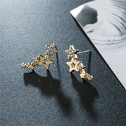 Gold star cluster earrings with sparkling crystals, ideal for jewelry websites, jewelry storage, diamond and jewelry lovers, and gifting for mom or special occasions.