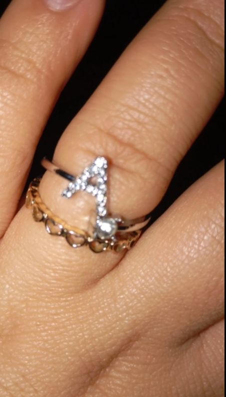 Elegant silver alphabet rings with gemstone accents displayed on hands, perfect for personalized jewelry options, showcasing jewelry designers' craftsmanship. 