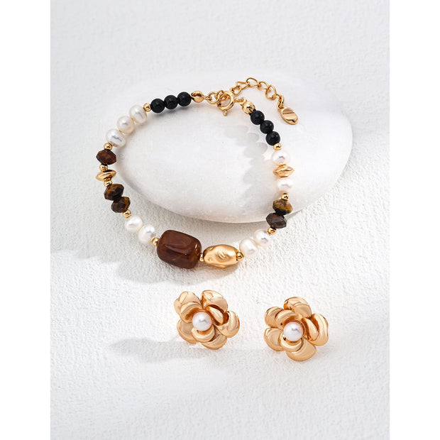 Elegant pearl and gemstone bracelet designed by leading jewelry designers, ideal for jewelry websites and jewelry storage. Featuring a mix of tiger's eye, onyx, and pearls, this vintage-inspired gem jewelry is perfect for mature women hairstyles, earrings piercing, and earrings rings. A must-have for jewelry of the sea lovers and those seeking jewelry with turquoise or engraving. Store in a jewelry case and maintain with jewelry cleaning for timeless appeal. Shop at jewelry brands offering body jewelry plus
