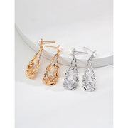 Vintage gold floral drop earrings with pearl accents, perfect for jewelry storage in a jewelry case. Ideal for jewelry designers, vintage jewelry lovers, and jewelry websites. A timeless addition for earrings piercing or body jewelry plus collections, suitable for jewelry brands and mature women hairstyles.