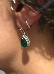 Vintage teardrop earrings with green gemstones and intricate silver detailing, perfect for jewelry storage, jewelry cleaning, and featuring on jewelry websites for vintage jewelry enthusiasts.