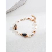 Elegant pearl and black onyx bracelet with 925 silver and vintage gold accents, perfect for jewelry storage, designed by jewelry designers, and ideal for pairing with gem jewelry, turquoise jewelry, or vintage jewelry. Featured on top jewelry websites and jewelry brands.