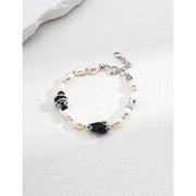 Elegant pearl and black onyx bracelet with 925 silver and vintage gold accents, perfect for jewelry storage, designed by jewelry designers, and ideal for pairing with gem jewelry, turquoise jewelry, or vintage jewelry. Featured on top jewelry websites and jewelry brands.
