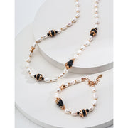 Elegant pearl and black onyx bracelet with 925 silver and vintage gold accents, perfect for jewelry storage, designed by jewelry designers, and ideal for pairing with gem jewelry, turquoise jewelry, or vintage jewelry. Featured on top jewelry websites and jewelry brands.